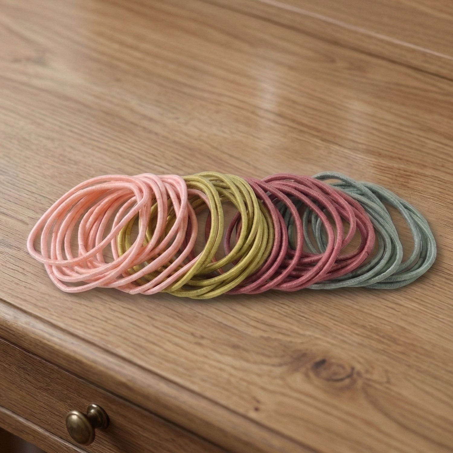 Collection of 40 elastic hair bands in various neutral shades, lightweight for comfort.
