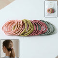 Set of 40 neutral elastic hair bands, offering a soft yet strong hold for all hair types.
