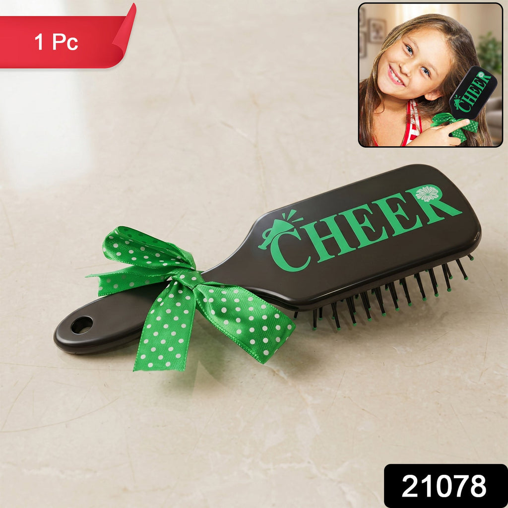 Cute printed kids hair brush featuring a ribbon bow handle, ideal for daily grooming.