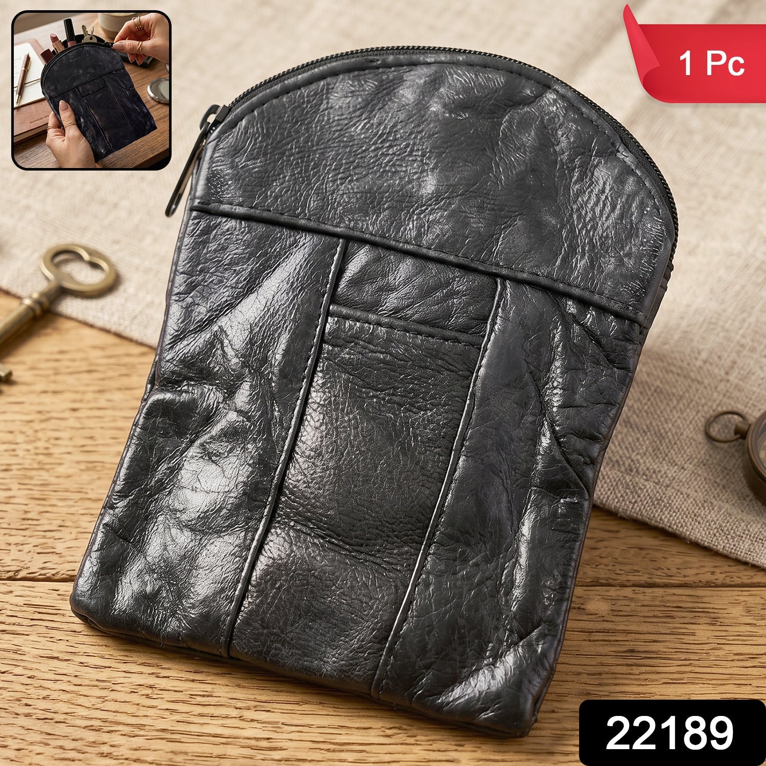 Close-up of the black leather mini pouch showing the zipper and front slip pocket.