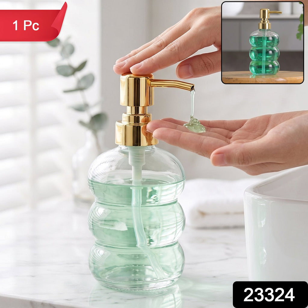 Clear glass soap dispenser with gold pump for bathroom