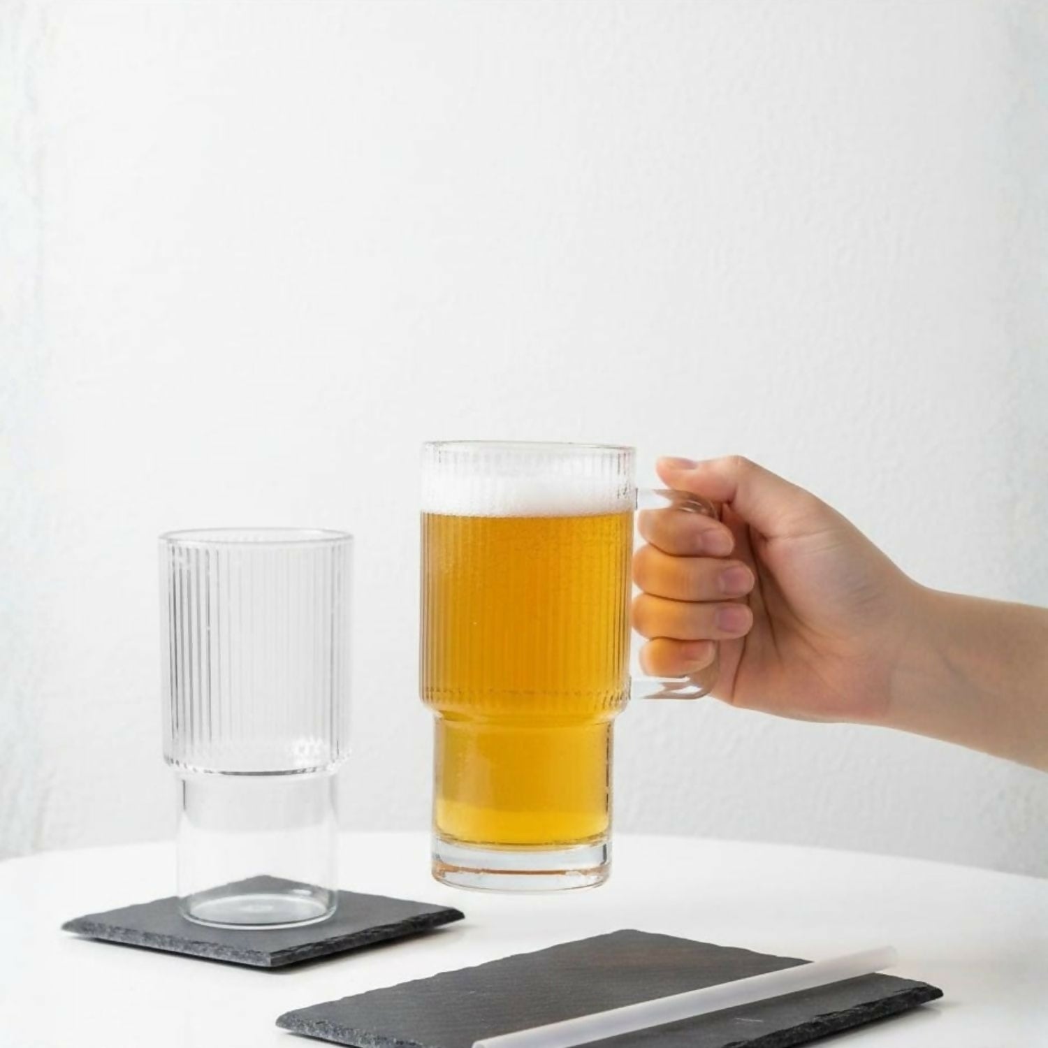 Close-up of spill-resistant lid and straw opening on glass tumbler